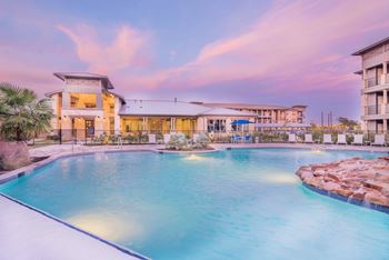 A large swimming pool in front of a building.
